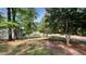 Lush yard with mature trees surrounding the property, providing shade and privacy at 108 Horseman Dr, Louisburg, NC 27549