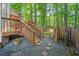 A lovely backyard featuring a wooden deck with railings, a small lawn, and a wooden fence with gated access at 11 Bridgeport Dr, Durham, NC 27713