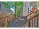 Charming backyard featuring stone pavers leading to a wooden fence and staircase to the home at 11 Bridgeport Dr, Durham, NC 27713