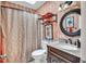 Bathroom with designer wallpaper, round vanity mirror, and shower with curtain at 11 Bridgeport Dr, Durham, NC 27713