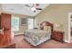 Comfortable bedroom featuring a ceiling fan and a large bed with patterned comforter and bedside tables at 11 Bridgeport Dr, Durham, NC 27713