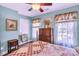 Charming bedroom featuring a bed with a quilt, a dresser, windows with floral curtains, and blue walls at 11 Bridgeport Dr, Durham, NC 27713