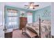 Cozy bedroom featuring a bed with a quilt, an antique wooden dresser, and natural light from the windows at 11 Bridgeport Dr, Durham, NC 27713
