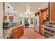 Spacious kitchen with granite counters, stainless steel appliances, brick floors, and ample cabinetry at 11 Bridgeport Dr, Durham, NC 27713