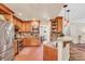 Modern kitchen with stainless steel appliances, wood cabinets, brick floors, and granite countertops at 11 Bridgeport Dr, Durham, NC 27713