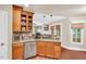 Kitchen area featuring wood cabinets, granite countertops, stainless steel appliances, and open layout at 11 Bridgeport Dr, Durham, NC 27713