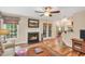 Living room featuring fireplace, hardwood floors, bright windows, and an open layout at 11 Bridgeport Dr, Durham, NC 27713