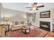 Living room featuring fireplace, hardwood floors, bright windows, and a comfortable couch at 11 Bridgeport Dr, Durham, NC 27713