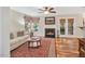 Cozy living room featuring hardwood floors, fireplace, bright windows, and access to a patio at 11 Bridgeport Dr, Durham, NC 27713