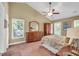 This primary bedroom has vaulted ceilings, a ceiling fan, and large wood furniture at 11 Bridgeport Dr, Durham, NC 27713