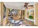 This cozy screened porch features a comfortable lounge chair, potted plants, and a ceiling fan for comfort at 11 Bridgeport Dr, Durham, NC 27713