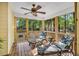 The screened-in porch features comfy lounge chairs with wooded views, creating the perfect spot for relaxation at 11 Bridgeport Dr, Durham, NC 27713