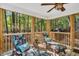 Enjoy the wooded views from this lovely screened-in porch featuring floral-patterned chaise lounges and natural light at 11 Bridgeport Dr, Durham, NC 27713