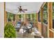 Relax on this screened-in porch featuring two lounge chairs with natural light and lovely wooded views at 11 Bridgeport Dr, Durham, NC 27713