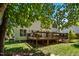 A large wooden back deck with black metal railings is attached to this home at 11 Smoketree Ct, Durham, NC 27712