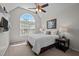 Bright bedroom with large arched window, neutral color palette, and decorative lamps at 11 Smoketree Ct, Durham, NC 27712