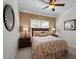 Cozy bedroom features neutral paint, a ceiling fan, and a stylish mirror at 11 Smoketree Ct, Durham, NC 27712