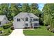 Charming two-story home featuring a well-manicured lawn, attached garage, and traditional architectural details at 11 Smoketree Ct, Durham, NC 27712
