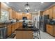 Bright kitchen featuring a center island, stainless appliances, and wooden cabinetry at 11 Smoketree Ct, Durham, NC 27712