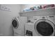 Bright laundry room with modern machines, utility sink, and ample shelving for storage of supplies at 11 Smoketree Ct, Durham, NC 27712