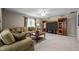 Comfortable living room with a large sectional sofa, neutral carpet, and a wooden entertainment center at 11 Smoketree Ct, Durham, NC 27712