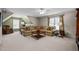Spacious living room with a large sectional sofa, neutral carpet, and windows that provide lots of natural light at 11 Smoketree Ct, Durham, NC 27712