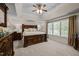 Spacious main bedroom features a large wooden bed frame and large window with lots of natural light at 11 Smoketree Ct, Durham, NC 27712