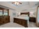Large main bedroom with wooden bed frame, ceiling fan, and neutral paint with white trim at 11 Smoketree Ct, Durham, NC 27712