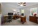 Office with desk and sewing machine, neutral carpet, a ceiling fan, and windows that provide lots of natural light at 11 Smoketree Ct, Durham, NC 27712