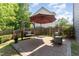 Backyard patio with brick pavers, patio furniture, and decorative foliage in a well maintained landscape at 1101 Washhouse Ln, Wake Forest, NC 27587