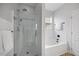 Elegant bathroom featuring a glass-enclosed shower and a soaking tub by the window at 1101 Washhouse Ln, Wake Forest, NC 27587
