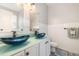 This modern bathroom features dual vessel sinks, tile and updated fixtures at 1101 Washhouse Ln, Wake Forest, NC 27587