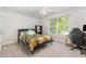 This is a cozy bedroom featuring neutral paint, natural light, and a ceiling fan at 1101 Washhouse Ln, Wake Forest, NC 27587