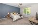 This primary bedroom offers an accent wall, natural lighting, and a neutral color palette at 1101 Washhouse Ln, Wake Forest, NC 27587
