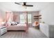 This spacious bedroom features natural light, carpet, and a four post bed at 1101 Washhouse Ln, Wake Forest, NC 27587