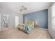 Inviting bedroom featuring a blue accent wall, plush carpet, and plenty of natural light at 1101 Washhouse Ln, Wake Forest, NC 27587