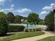 A clean and inviting community pool with plenty of lounge chairs and landscaping at 1101 Washhouse Ln, Wake Forest, NC 27587