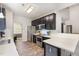 Bright open kitchen featuring white countertops, stainless steel appliances, dark cabinets, and a eat-in nook at 1101 Washhouse Ln, Wake Forest, NC 27587