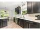 Bright kitchen featuring stainless steel appliances, dark cabinetry, white countertops, and subway tile backsplash at 1101 Washhouse Ln, Wake Forest, NC 27587