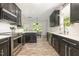 Modern kitchen with stainless steel appliances, dark cabinets, white countertops, and subway tile backsplash at 1101 Washhouse Ln, Wake Forest, NC 27587
