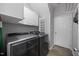 Convenient laundry room featuring modern washer and dryer, cabinets, and shelving for optimal organization at 1101 Washhouse Ln, Wake Forest, NC 27587