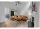 Comfortable living room features high ceilings, a ceiling fan, and a brown leather sectional sofa at 1101 Washhouse Ln, Wake Forest, NC 27587