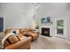 Inviting living room with a cozy fireplace and a plush leather sofa with decorative pillows at 1101 Washhouse Ln, Wake Forest, NC 27587