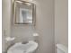 Bathroom features a sink, toilet, and mirrored wall at 1112 Mark St, Raleigh, NC 27601