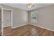 Bedroom showcasing wood-look floors and access to the bathroom at 1112 Mark St, Raleigh, NC 27601