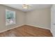 Bedroom with wood-look flooring, a ceiling fan and a bright window at 1112 Mark St, Raleigh, NC 27601
