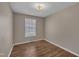 Well-lit bedroom with wood-look flooring and a bright window at 1112 Mark St, Raleigh, NC 27601