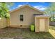 House exterior showing vinyl siding and attached storage shed with a newly installed wood fence at 1112 Mark St, Raleigh, NC 27601