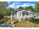 Charming home featuring gray siding, white trim, inviting front porch and partially shaded yard at 1112 Mark St, Raleigh, NC 27601