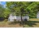 Charming home with a well-manicured lawn and mature shade tree in the front yard at 1112 Mark St, Raleigh, NC 27601